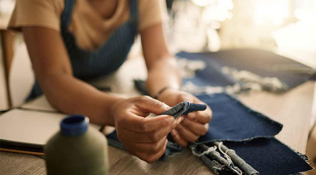 employee inspecting fabric at place of business